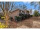 Side view of brick house shows access and lush landscaping with a gentle slope at 405 Putting Green Ln, Roswell, GA 30076