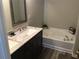 Bathroom features a double sink vanity with a marble countertop and a built-in soaking tub at 789 Celeste Sw Ln, Atlanta, GA 30331