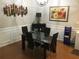 Dining area featuring a glass table, modern chairs, and decorative wall art at 789 Celeste Sw Ln, Atlanta, GA 30331