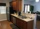 Functional kitchen with stainless steel appliances, wood cabinets, and an open layout connecting to the living area at 789 Celeste Sw Ln, Atlanta, GA 30331