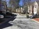 A picturesque street view of townhomes in a peaceful neighborhood with mature trees and well-maintained landscaping at 789 Celeste Sw Ln, Atlanta, GA 30331