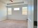 Cozy bedroom featuring plush carpeting, ample natural light, and ceiling fan at 1649 Auburn Ridge Way, Dacula, GA 30019