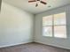Bedroom featuring plush carpeting, large window, and ceiling fan at 1649 Auburn Ridge Way, Dacula, GA 30019