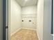A compact laundry room area with washer-dryer hookups and a wire rack for storage at 1649 Auburn Ridge Way, Dacula, GA 30019