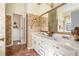 Bathroom featuring double sinks and vanity with an adjacent room beyond a doorway at 606 Wedgewood Dr, Woodstock, GA 30189