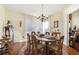 Sunlit dining room with hardwood floors, a chandelier, and a large window at 606 Wedgewood Dr, Woodstock, GA 30189