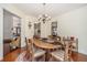 Bright dining room with wood table set for six, chandelier, and view to kitchen at 606 Wedgewood Dr, Woodstock, GA 30189