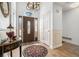 Elegant foyer featuring a decorative front door, chandelier, and tile flooring at 606 Wedgewood Dr, Woodstock, GA 30189