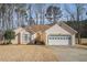 Welcoming single-story home featuring an attached two-car garage, set amidst a tranquil wooded neighborhood at 606 Wedgewood Dr, Woodstock, GA 30189