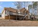 Rear exterior view showing wood deck, steps, and a covered area beneath the deck at 606 Wedgewood Dr, Woodstock, GA 30189