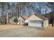 Charming single-story home with attached two-car garage and well-maintained lawn surrounded by mature trees at 606 Wedgewood Dr, Woodstock, GA 30189