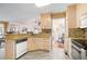 Charming kitchen with tile flooring and a view into the adjacent breakfast nook at 606 Wedgewood Dr, Woodstock, GA 30189