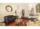 Cozy living room featuring hardwood floors, stylish furniture, and views of the front entrance at 606 Wedgewood Dr, Woodstock, GA 30189