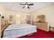 Main bedroom suite featuring a tray ceiling, large bed, and an ensuite bath at 606 Wedgewood Dr, Woodstock, GA 30189