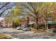 Brick condo building featuring mature trees, greenery, and covered doorways at 791 Wylie Se St # 105, Atlanta, GA 30316