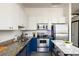 Modern kitchen featuring white and blue cabinets, stainless steel appliances, and a kitchen island at 791 Wylie Se St # 105, Atlanta, GA 30316