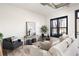 Bright living room with neutral furniture, decor, white brick wall, and a large window with black trim at 791 Wylie Se St # 105, Atlanta, GA 30316