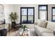 Bright living room featuring neutral furniture, plants, and a large window with dark trim at 791 Wylie Se St # 105, Atlanta, GA 30316