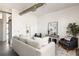 Bright living room with neutral furniture, decor, a ladder, and a large duct in the ceiling at 791 Wylie Se St # 105, Atlanta, GA 30316