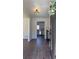 Bright foyer with hardwood floors offering a glimpse into the modern kitchen at 1038 Knotts Pointe Dr, Woodstock, GA 30188