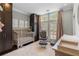 Well-lit Bedroom with wooden crib, seating area and storage cabinets at 2934 Hermance Ne Dr, Atlanta, GA 30319