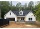 Charming new construction home featuring white siding, stone accents and an attached two car garage at 345 Evie Ln, Canton, GA 30115