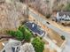 Aerial view showcasing the home's roof, landscaping, and paved driveway at 3605 Summit Gate Dr, Suwanee, GA 30024