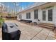 Backyard patio with a grill, outdoor seating, and view of the home's exterior at 3605 Summit Gate Dr, Suwanee, GA 30024
