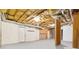 Unfinished basement with exposed ceiling, duct work, concrete floor and several doors at 3605 Summit Gate Dr, Suwanee, GA 30024