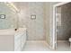 Well-lit bathroom features vanity and a vintage wallpaper at 3605 Summit Gate Dr, Suwanee, GA 30024