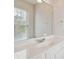 Bright bathroom with white vanity, large mirror, and natural light from a window at 3605 Summit Gate Dr, Suwanee, GA 30024
