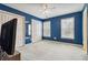 Blue-walled bedroom with two windows, closet space, ceiling fan, and light colored carpet at 3605 Summit Gate Dr, Suwanee, GA 30024