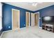 Blue bedroom with carpet, ceiling fan and view of bathroom and hallway at 3605 Summit Gate Dr, Suwanee, GA 30024