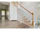 Bright foyer showcases hardwood floors, a staircase with white wooden handrail, and a storage cabinet at 3605 Summit Gate Dr, Suwanee, GA 30024