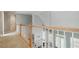 Hallway with a wooden railing, leading to stairs and bedrooms with white doors at 3605 Summit Gate Dr, Suwanee, GA 30024