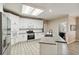 Well-lit modern kitchen featuring white cabinets, stainless steel appliances, and a center island at 3605 Summit Gate Dr, Suwanee, GA 30024