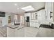 Open concept kitchen with stainless steel appliances, white cabinets, and granite countertops at 3605 Summit Gate Dr, Suwanee, GA 30024