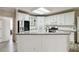 Modern kitchen boasts white cabinets, stainless steel appliances, and ample counter space at 3605 Summit Gate Dr, Suwanee, GA 30024