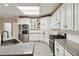 Well-equipped kitchen features stainless steel appliances, granite counters, and ample storage at 3605 Summit Gate Dr, Suwanee, GA 30024