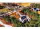Stunning aerial view of a secluded home surrounded by lush trees and a long driveway, perfect for private living at 136 Rainey Rd, Temple, GA 30179