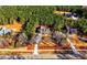 Aerial view of several homes in a wooded community with mature trees and well-manicured lawns at 136 Rainey Rd, Temple, GA 30179