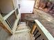New construction home featuring a back porch with wooden stairs and black metal railings at 136 Rainey Rd, Temple, GA 30179