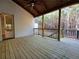 Spacious covered back porch with wood railing and access to the backyard at 136 Rainey Rd, Temple, GA 30179