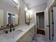 Bathroom boasts double sinks with marble countertop, modern fixtures and lighting at 136 Rainey Rd, Temple, GA 30179