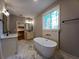 Bathroom showcasing double sink vanity, free standing tub, and large window providing great natural light at 136 Rainey Rd, Temple, GA 30179