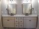Bathroom features a double sink vanity with marble countertop, and framed mirrors at 136 Rainey Rd, Temple, GA 30179