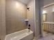 Bathroom has a tiled shower, a neutral color scheme, and an adjacent vanity at 136 Rainey Rd, Temple, GA 30179