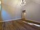 Bedroom showcasing wood floors, vaulted ceilings, elegant chandelier, and a hallway to the bathroom at 136 Rainey Rd, Temple, GA 30179