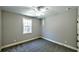 Bedroom with a ceiling fan, carpet, natural light from window, and neutral paint at 136 Rainey Rd, Temple, GA 30179