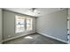 Bright bedroom featuring neutral walls, a ceiling fan, two windows, and plush carpeting at 136 Rainey Rd, Temple, GA 30179